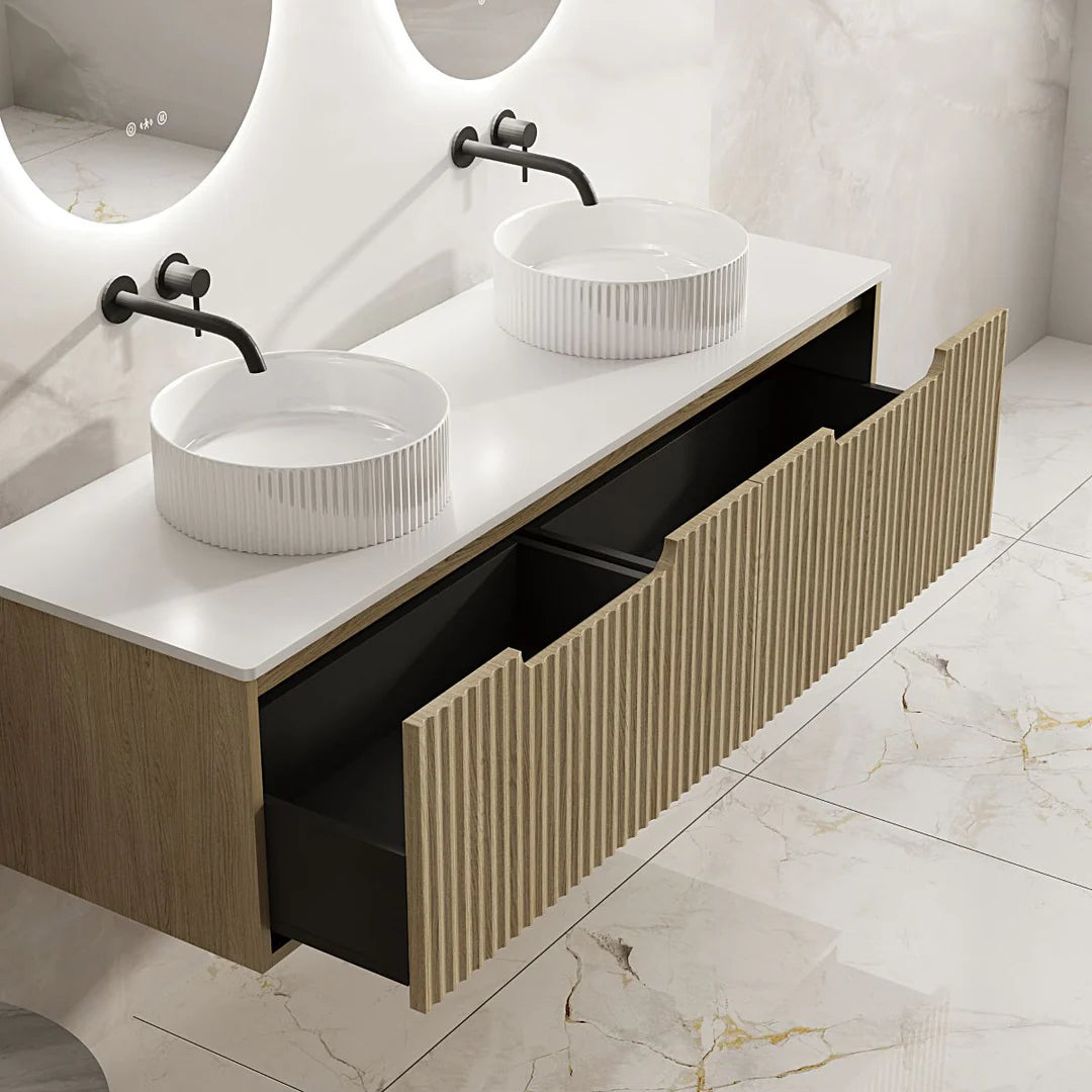 Bathroom vanity with two white sinks and black fixtures on a marble floor.