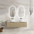 Bathroom vanity with double sink and illuminated mirrors in a modern setting.