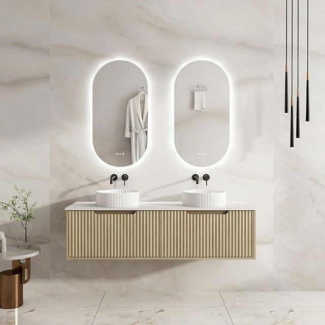 Bathroom vanity with double sink and illuminated mirrors in a modern setting.