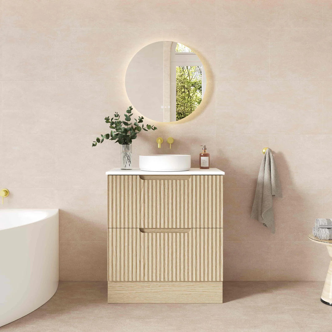Bathroom with a vanity unit, round mirror, and decorative elements.