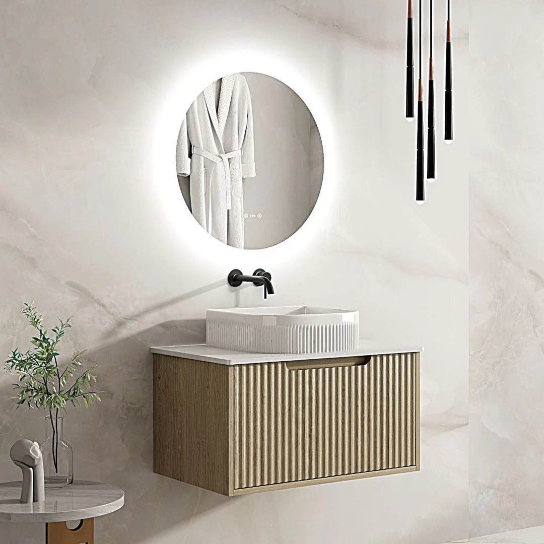 Modern bathroom with a vanity, round mirror, and decorative elements.