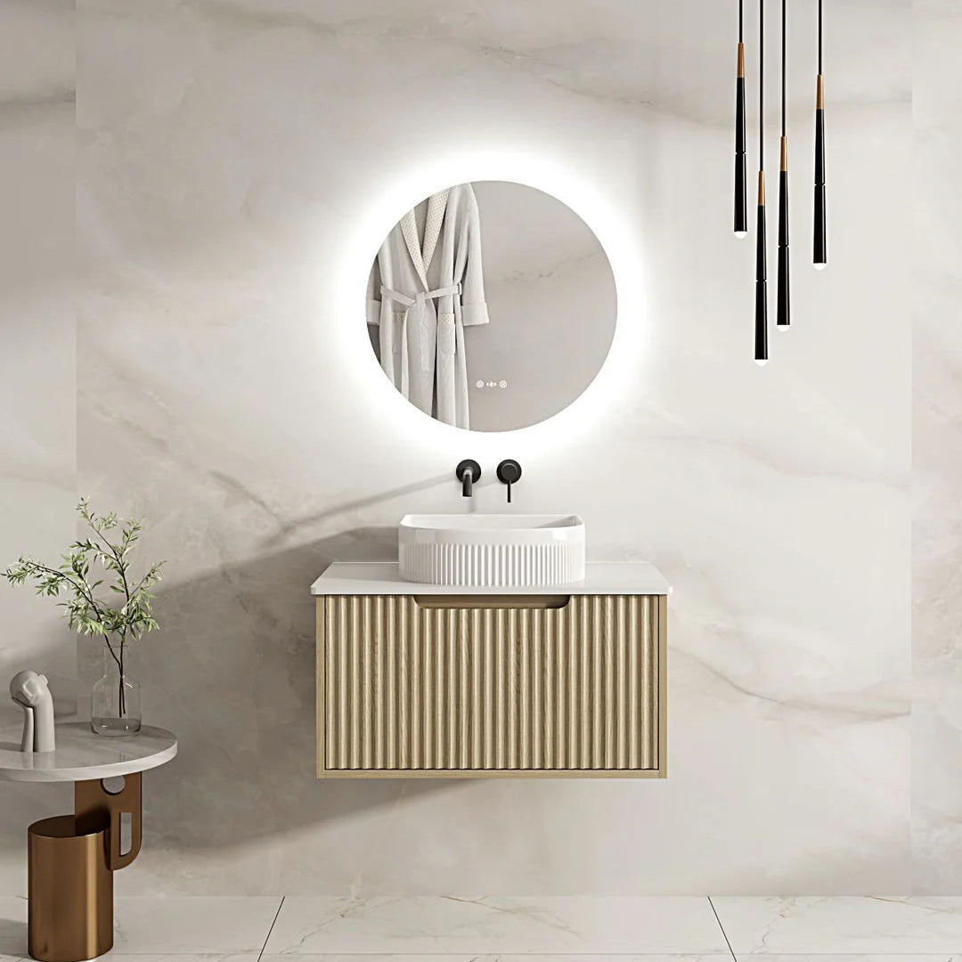 Modern bathroom with a floating vanity unit, round mirror, and decorative elements.