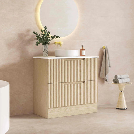 Bathroom vanity with sink, mirror, and decorative items against a beige wall.