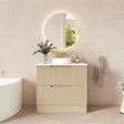 Bathroom vanity with round mirror, sink, and decorative elements against a beige wall.