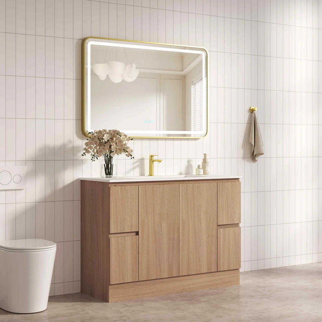Bathroom with wooden vanity, mirror, and toilet