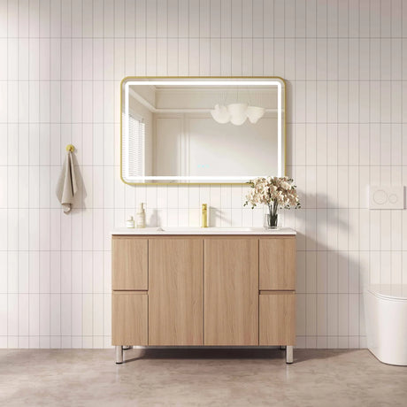 Bathroom vanity with wooden cabinet, mirror, and sink against a tiled wall.