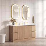 Bathroom vanity with wooden cabinets, white countertop, and illuminated mirrors.
