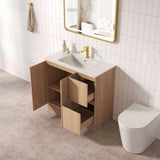 Bathroom with wooden vanity, sink, and toilet against a tiled wall.