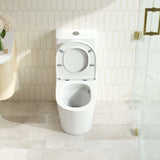 White toilet in a bathroom with tiled walls and floor