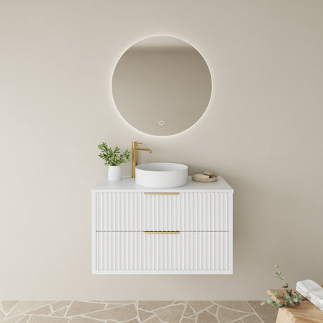 Bathroom vanity with round mirror, sink, and decorative elements on a neutral wall.