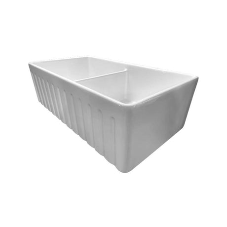 A white ceramic farmhouse-style double basin sink with vertical fluted sides, shown on a plain white background.