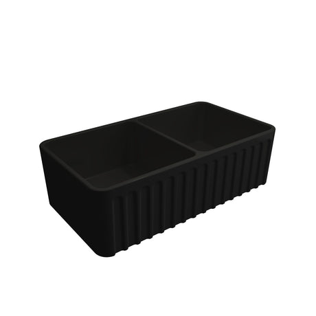 A matte black double-bowl farmhouse kitchen sink with a central divider, shown from an elevated angle on a solid white background.