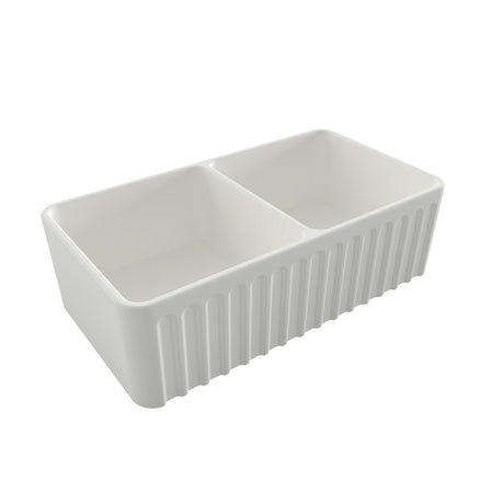 A white double-bowl farmhouse kitchen sink with a rectangular shape and integrated drain, shown from an elevated angle on a solid white background.