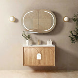 Bathroom vanity with wooden cabinet, mirror, and decorative items against a beige wall.