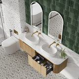 Bathroom with double sink vanity, mirrors, and a toilet.