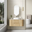 Bathroom with wooden vanity, mirror, and window view
