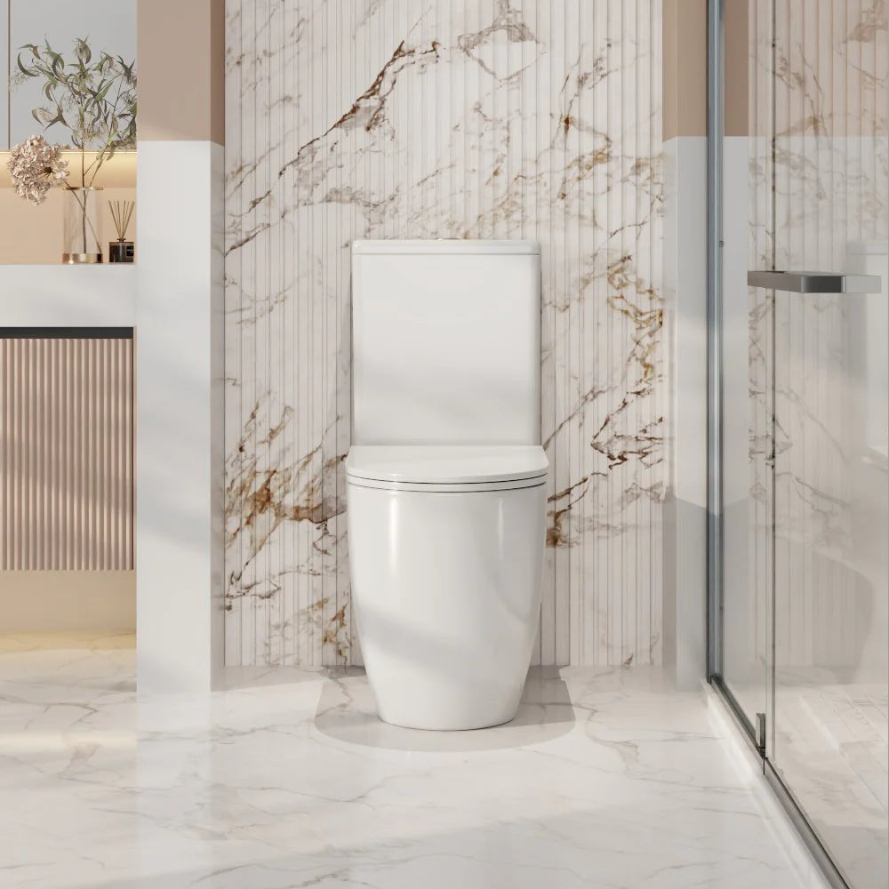 Modern toilet in a bathroom with marble walls and a glass shower door.