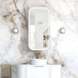 Bathroom with marble wall, white vanity, and mirror