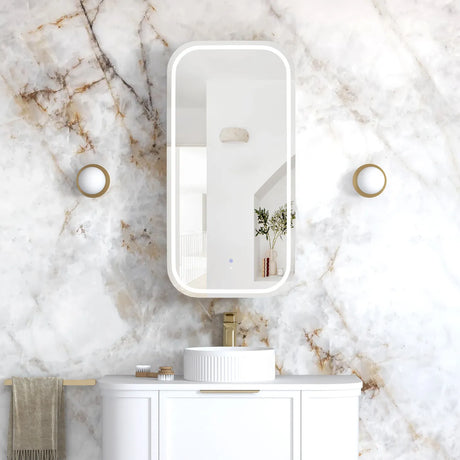 Bathroom with marble wall, white vanity, and mirror