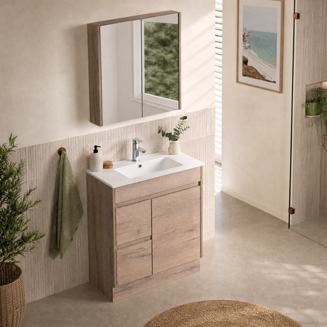 A modern bathroom vanity with a light oak wood cabinet, white ceramic sink, and chrome faucet, styled in a bright, contemporary bathroom with a matching wood-look mirror.