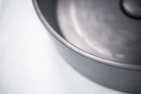 Close-up of the ARLO Round Concrete Basin in Charcoal, highlighting its smooth matte finish and refined edges, showcasing the craftsmanship and modern aesthetic of the design.